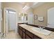 Bright bathroom features double vanity, granite countertops, and a well-lit mirror at 42 S Nevada Way, Gilbert, AZ 85233