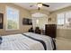 Bedroom with plantation shutters, tv, and ceiling fan at 42 S Nevada Way, Gilbert, AZ 85233