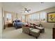 Spacious bedroom with a four-poster bed, plantation shutters, ceiling fan and cozy seating area at 42 S Nevada Way, Gilbert, AZ 85233