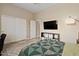 Bedroom features a comfortable bed and modern entertainment unit with a flat-screen TV at 42 S Nevada Way, Gilbert, AZ 85233