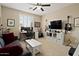 Cozy bedroom setup as a music room, features a ceiling fan and ample natural light at 42 S Nevada Way, Gilbert, AZ 85233