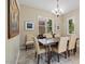 Formal dining room with neutral colors and elegant chandelier at 42 S Nevada Way, Gilbert, AZ 85233