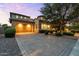 Stately home showcasing a driveway and a manicured lawn with mature trees at 42 S Nevada Way, Gilbert, AZ 85233