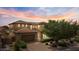Wide angle view of a well-maintained home featuring a large driveway, lush greenery and a spacious layout at 42 S Nevada Way, Gilbert, AZ 85233
