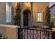 Charming front entrance with a dark wood door, landscaped yard, and a cozy seating area at 42 S Nevada Way, Gilbert, AZ 85233