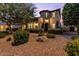Inviting front yard featuring mature trees, gravel landscaping, and a charming two-story home at 42 S Nevada Way, Gilbert, AZ 85233