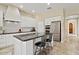 Stylish kitchen with white cabinets, island with seating, and stainless steel appliances at 42 S Nevada Way, Gilbert, AZ 85233