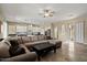 Open-concept living area with tile flooring, large sectional sofa and views to the kitchen at 42 S Nevada Way, Gilbert, AZ 85233