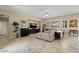 Spacious living room with tile floors, large windows, and comfortable seating arrangement at 42 S Nevada Way, Gilbert, AZ 85233