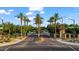 Community intersection featuring lush landscaping, mature palm trees, and well-maintained street at 42 S Nevada Way, Gilbert, AZ 85233