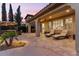 Covered patio with lounge chairs for relaxation and an outdoor dining area nearby at 42 S Nevada Way, Gilbert, AZ 85233