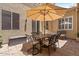 Inviting patio with an umbrella, seating, and stylish brick flooring perfect for outdoor dining and relaxation at 42 S Nevada Way, Gilbert, AZ 85233