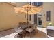 Cozy patio with a large umbrella, a table, and seating, ideal for enjoying outdoor meals and gatherings at 42 S Nevada Way, Gilbert, AZ 85233