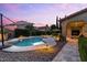 Twilight view of the pool and lush landscaping, highlighting the outdoor space at 42 S Nevada Way, Gilbert, AZ 85233