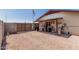 Backyard view highlighting the covered patio area, fenced perimeter, and gravel landscaping at 421 S 113Th Way, Mesa, AZ 85208