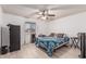Cozy bedroom featuring wood-look floors, ceiling fan, and ample natural light from the window at 421 S 113Th Way, Mesa, AZ 85208