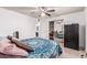 Bedroom with wood-look floors, ceiling fan, and sliding door closet, with a partial view of the ensuite bathroom at 421 S 113Th Way, Mesa, AZ 85208