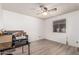 Bright bedroom with a ceiling fan, natural light, and wood look flooring at 421 S 113Th Way, Mesa, AZ 85208