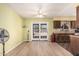 Bright dining area with sliding glass doors, wood-look flooring, and a view of the kitchen at 421 S 113Th Way, Mesa, AZ 85208