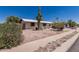 Single-story home featuring desert landscaping, a tall Saguaro Cactus, and an American flag at 421 S 113Th Way, Mesa, AZ 85208