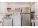 Functional laundry area includes a refrigerator, washer, dryer, and shelving at 421 S 113Th Way, Mesa, AZ 85208