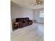 Comfortable living room with a ceiling fan and a plush brown reclining sofa at 421 S 113Th Way, Mesa, AZ 85208
