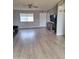 Bright living room with a ceiling fan, laminate flooring, and a window for natural light at 421 S 113Th Way, Mesa, AZ 85208