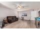 Cozy living room with neutral walls, wood flooring, and a comfortable brown sofa at 421 S 113Th Way, Mesa, AZ 85208