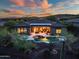 Aerial view of the backyard featuring a sparkling pool, spa, desert landscape, and mountain views at 42429 N Cross Timbers Ct, Anthem, AZ 85086