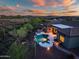Beautiful backyard oasis featuring a pool, spa, built-in grill, and desert views at 42429 N Cross Timbers Ct, Anthem, AZ 85086
