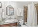 Bathroom featuring granite counter, dark cabinets, tub with tiled surround and shower curtain at 42429 N Cross Timbers Ct, Anthem, AZ 85086