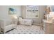 Cozy bedroom featuring a crib, a twin bed, and a large window with bright light at 42429 N Cross Timbers Ct, Anthem, AZ 85086