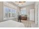 Bedroom featuring tile floors, plantation shutters, dresser, rocking chair, and a comfortable bed at 42429 N Cross Timbers Ct, Anthem, AZ 85086