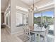 Bright dining area featuring an elegant chandelier and sliding glass doors to the outdoor space at 42429 N Cross Timbers Ct, Anthem, AZ 85086