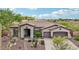 Charming single-story home with desert landscaping, mature trees, and a two-car garage at 42429 N Cross Timbers Ct, Anthem, AZ 85086