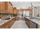 Well-appointed kitchen with stainless steel appliances, tile backsplash, granite countertops, and wood cabinets at 42429 N Cross Timbers Ct, Anthem, AZ 85086