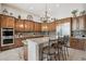 Lovely kitchen featuring an island with bar stool seating, granite countertops, and stainless steel appliances at 42429 N Cross Timbers Ct, Anthem, AZ 85086