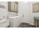 Bright laundry room features a washer, dryer, utility sink, storage cabinets, and access door at 42429 N Cross Timbers Ct, Anthem, AZ 85086