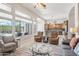 Bright living room featuring neutral tones, with seamless views of the backyard and access to the kitchen at 42429 N Cross Timbers Ct, Anthem, AZ 85086