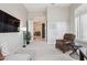 Living room showcasing neutral walls and carpet, cozy seating, and an open doorway to the dining room at 42429 N Cross Timbers Ct, Anthem, AZ 85086