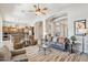 Spacious open-concept living room with high ceilings, a ceiling fan, and seamless flow to the kitchen at 42429 N Cross Timbers Ct, Anthem, AZ 85086