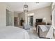 Serene main bedroom with stylish furnishings, an adjacent sitting area, and glass block wall feature at 42429 N Cross Timbers Ct, Anthem, AZ 85086