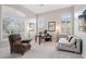 Office with plantation shutters, neutral walls and carpet, desk, daybed, and comfortable chair at 42429 N Cross Timbers Ct, Anthem, AZ 85086