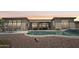 A luxurious backyard featuring a sparkling pool and an inviting outdoor dining and seating area on the patio at 42429 N Cross Timbers Ct, Anthem, AZ 85086