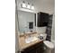 Bathroom with a well-lit mirror, granite vanity, dark wood cabinet, and tub with shower at 520 N Stapley Dr # 265, Mesa, AZ 85203