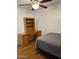 Bedroom with laminate floor, ceiling fan and wooden desk with bookshelf at 520 N Stapley Dr # 265, Mesa, AZ 85203