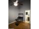 Bedroom features a black computer desk, ceiling fan, and view into the bathroom at 520 N Stapley Dr # 265, Mesa, AZ 85203
