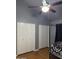 Bedroom featuring two white closets, ceiling fan, and canopy bed frame at 520 N Stapley Dr # 265, Mesa, AZ 85203