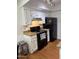Cozy kitchen with white cabinets, granite countertops, and black appliances at 520 N Stapley Dr # 265, Mesa, AZ 85203