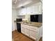 Well-lit kitchen with granite countertops, stainless steel sink, and white cabinets at 520 N Stapley Dr # 265, Mesa, AZ 85203